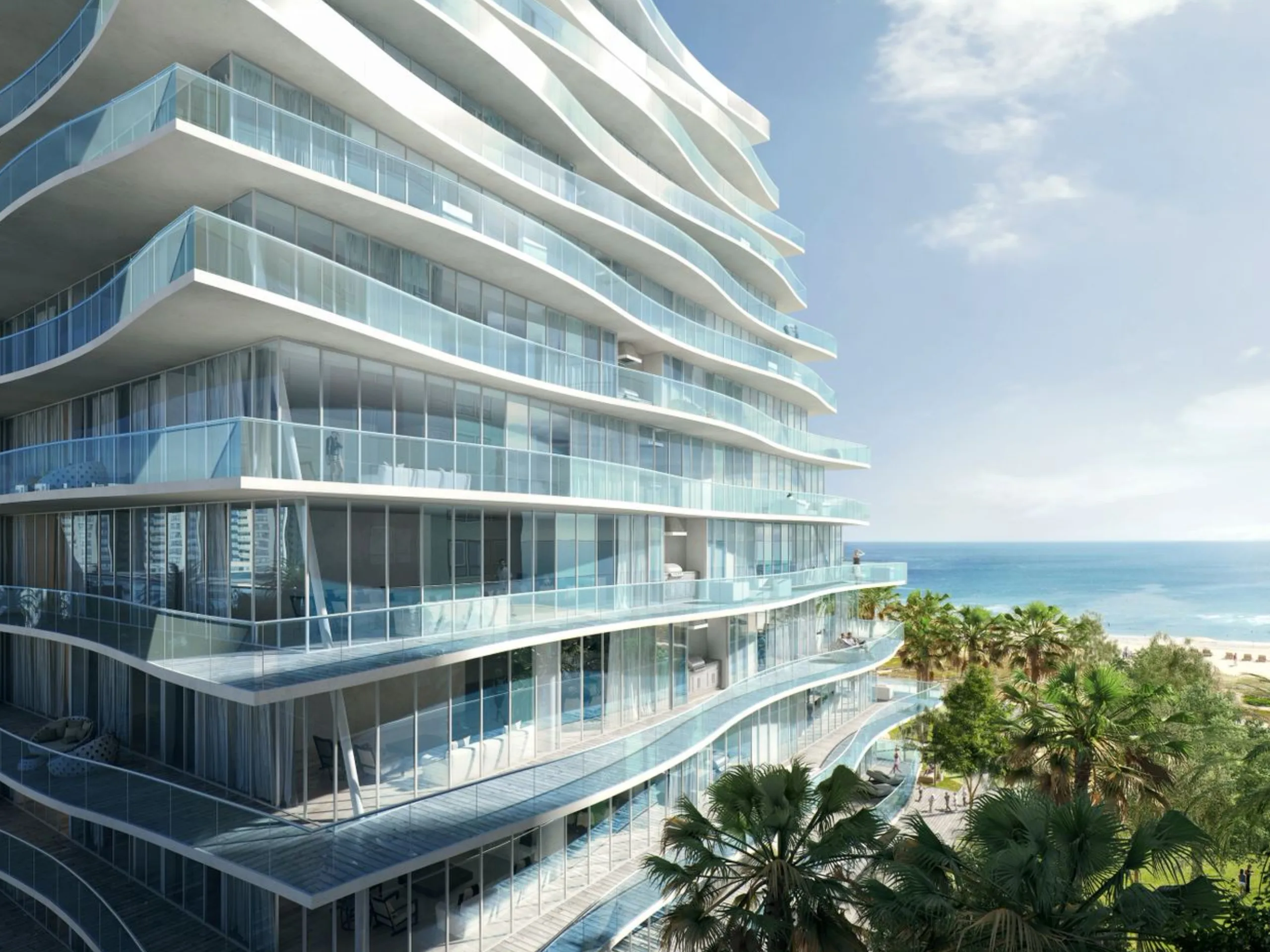 Modern high-rise building with curved glass balconies overlooking the ocean