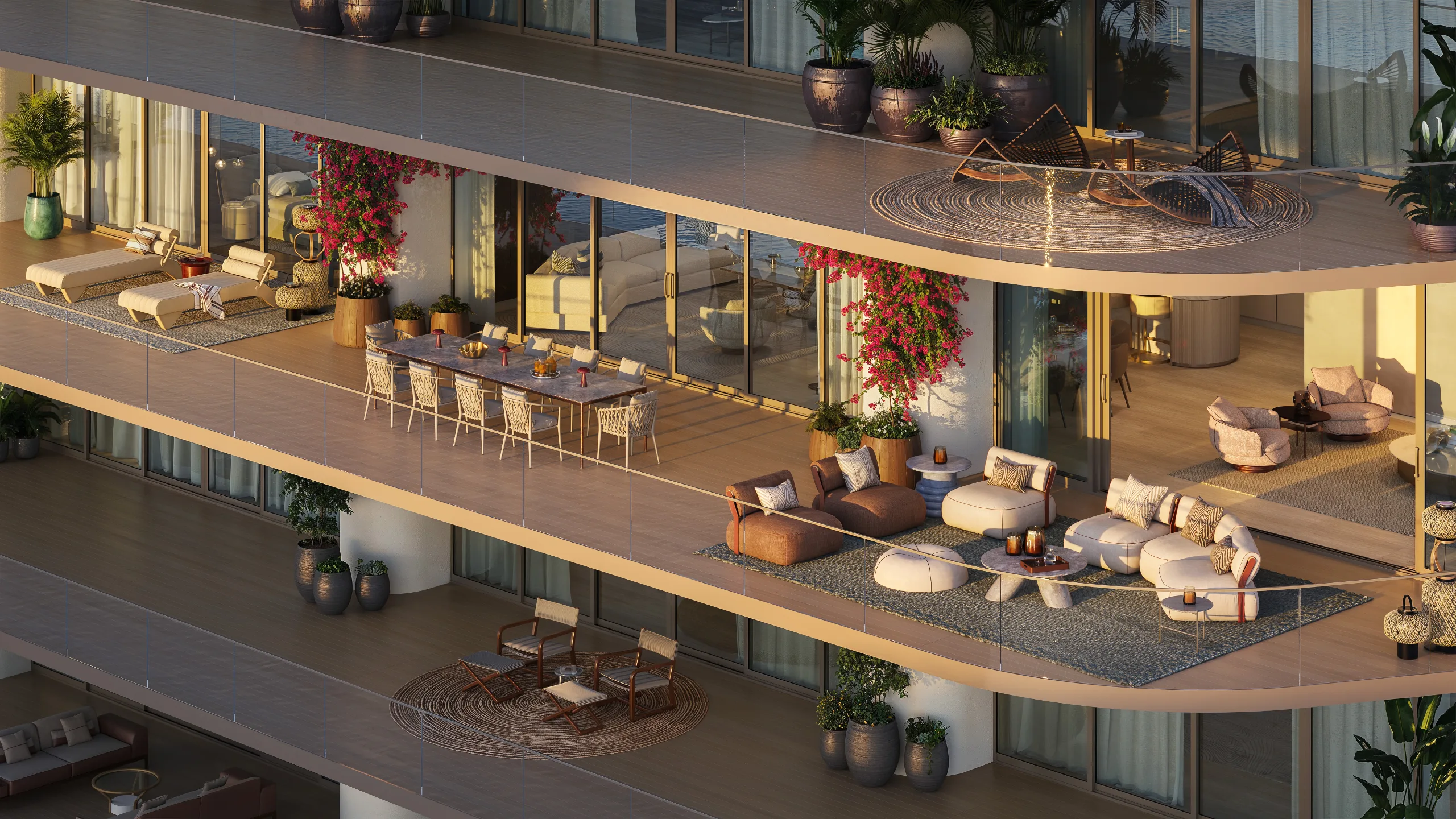Balcony with outdoor furniture, potted plants, and a view of the water at sunset