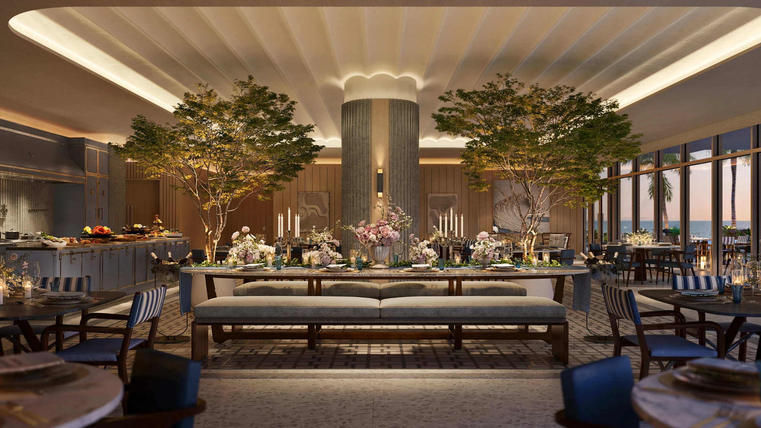 Indoor dining space with large windows overlooking the ocean, decorated with floral centerpieces and candlelit tables