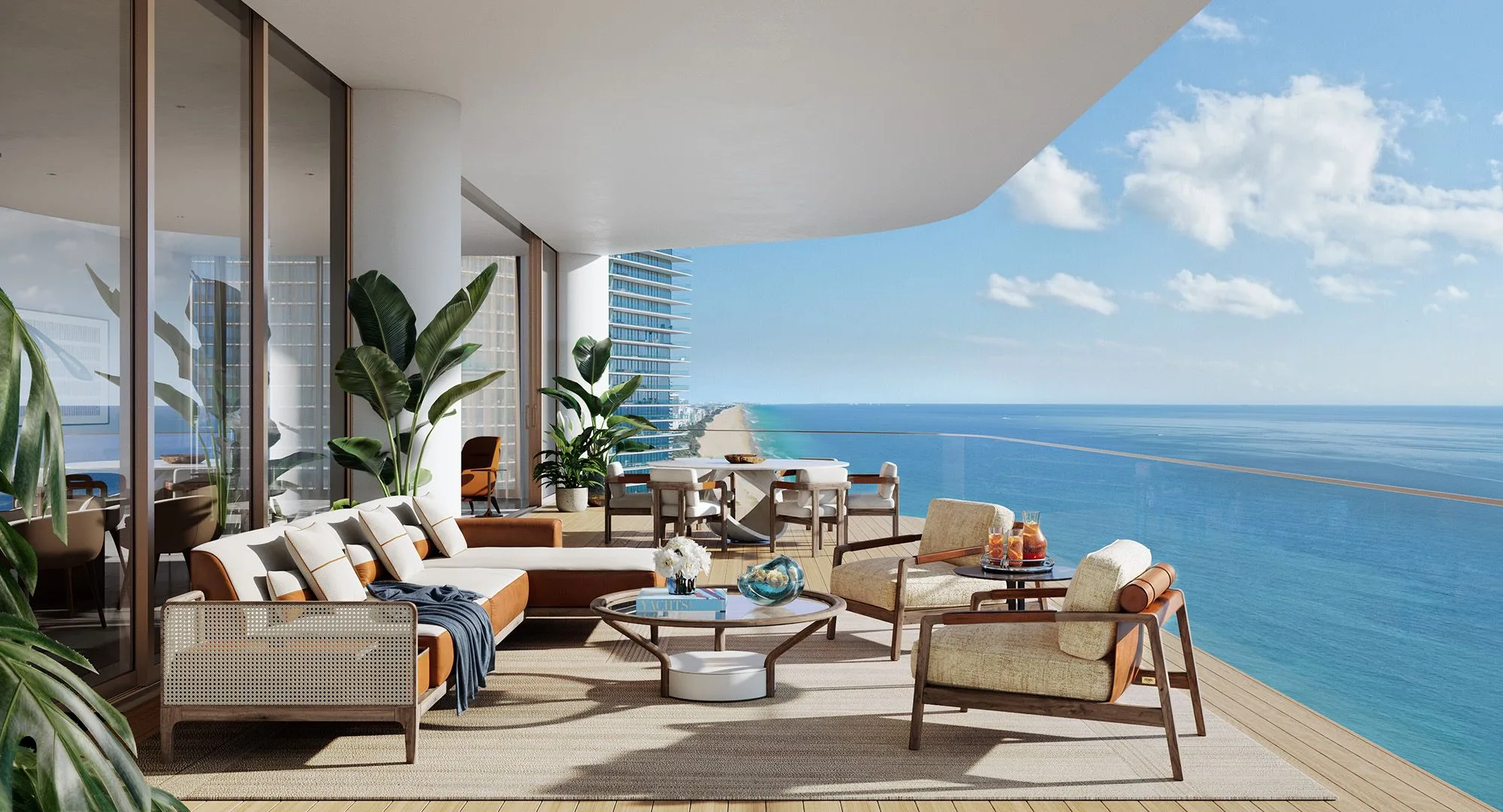 Balcony with seating area overlooking the ocean and city skyline