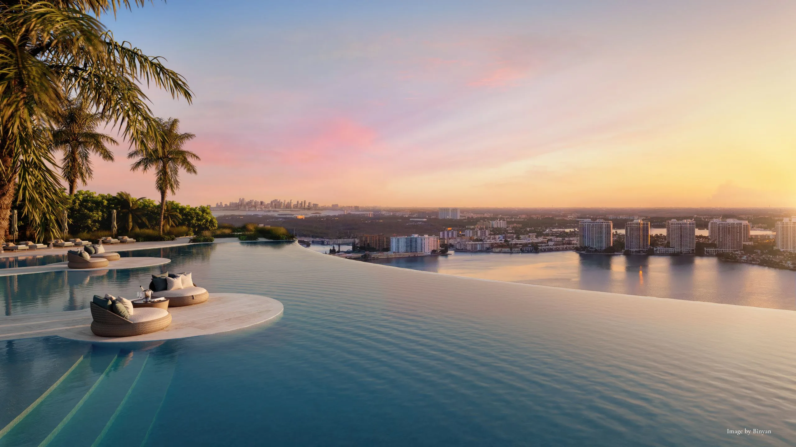 Infinity pool overlooking city skyline at sunset with palm trees on the side